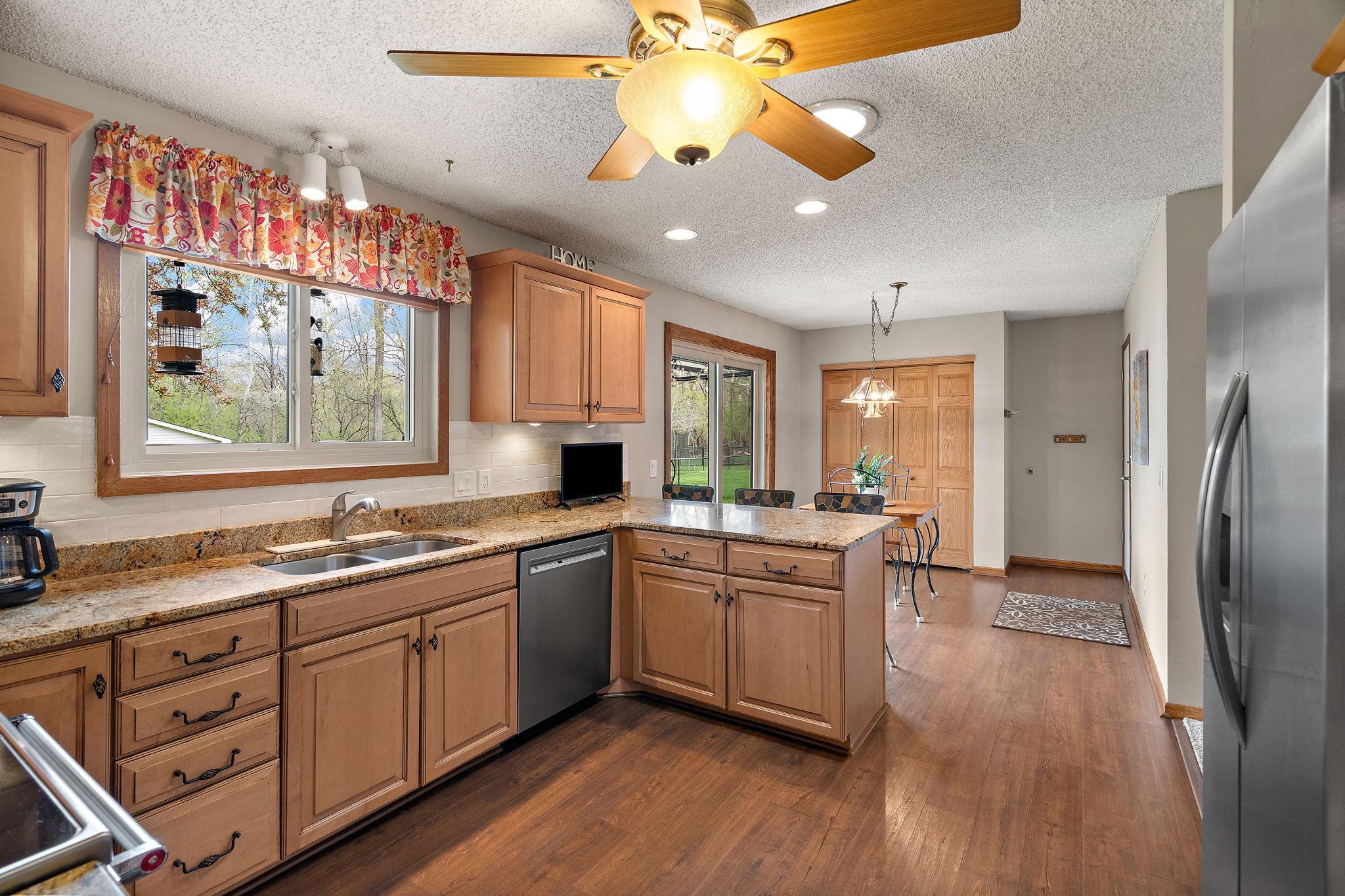 The kitchen also has a eat-in bar area for early morning breakfasts or to host buffet style serving during a party. The kitchen flows into the informal dining room.