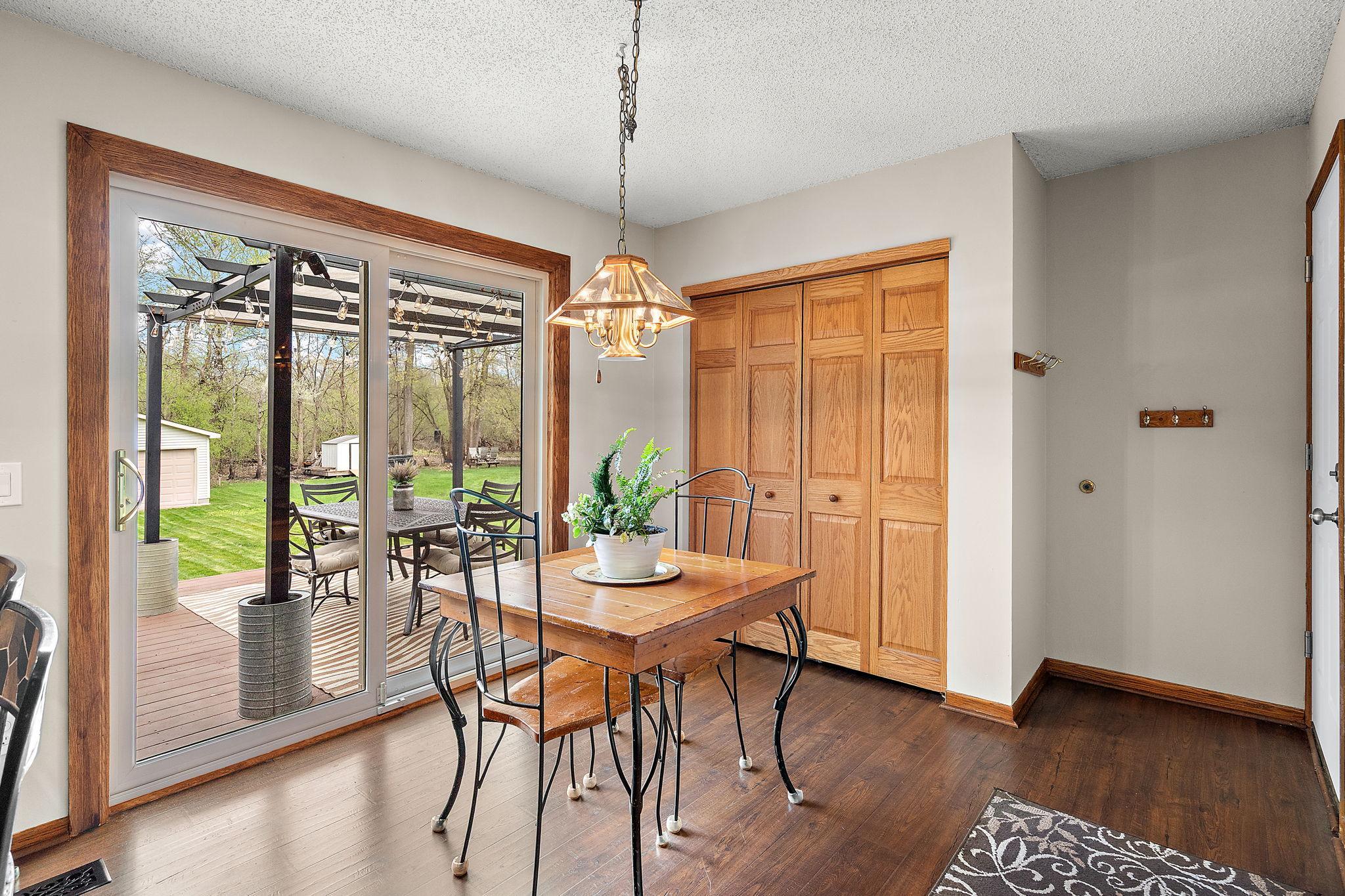 The informal dining room or breakfast nook has garage door access on the right, additional coat closets in the center and access to the backyard and deck on the left.