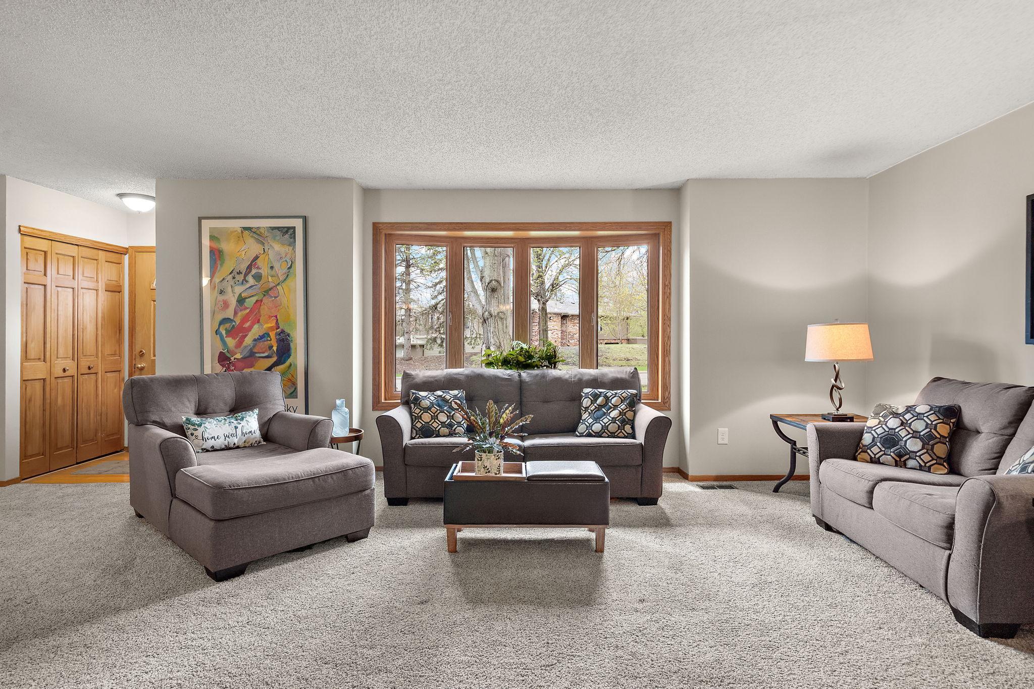 The living room is a formal gathering space for guests or hosting intimate family parties.