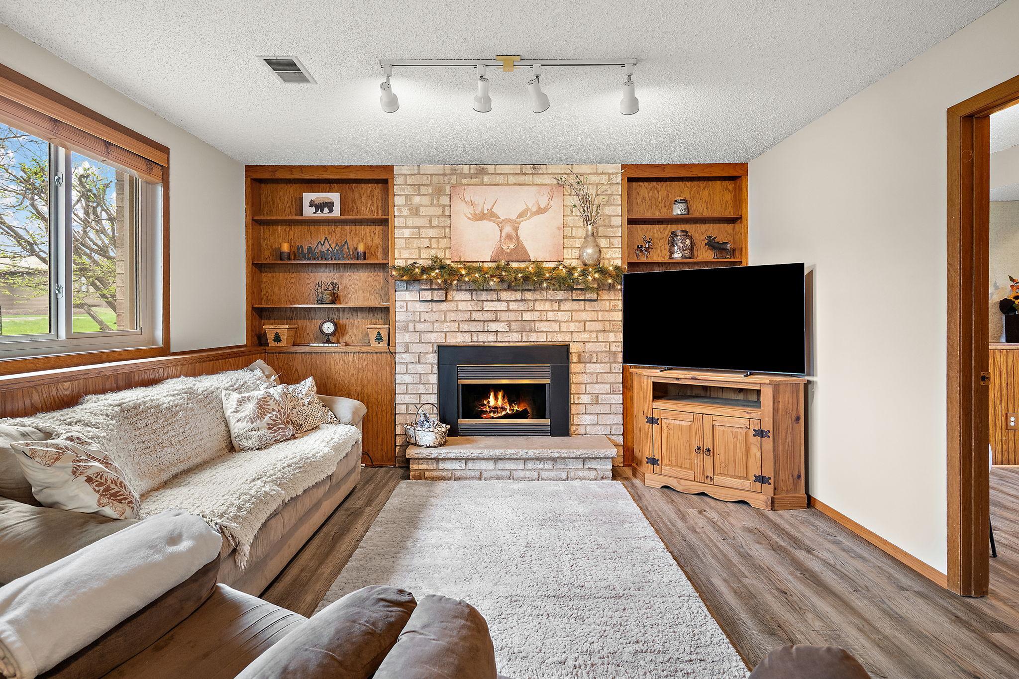 The lower level recreation/family room with a gas fireplace that was refurbished and tuned up in February 2026 so it is ready to go!