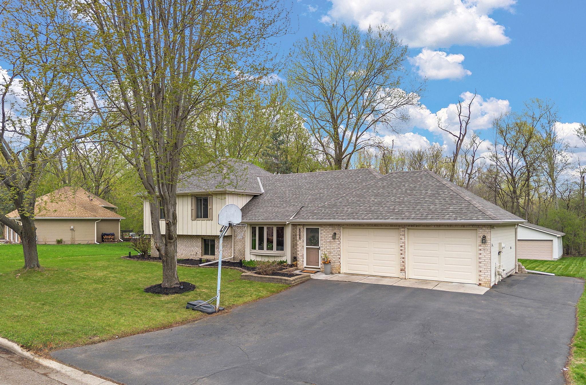 The property has second two car heated garage in the backyard, visible to the far right of the photo behind the attached garage that is ideal for extra storage or for a workroom/hobby space.