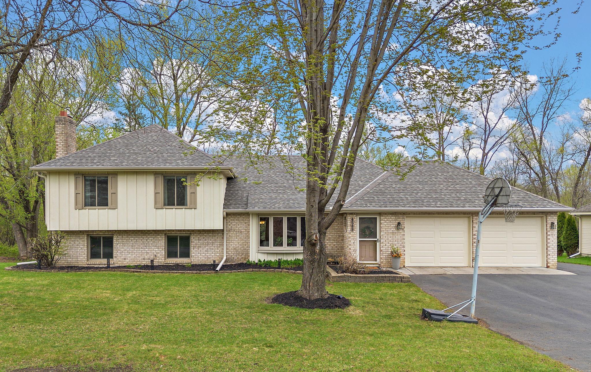 This property features mature trees, an asphalt driveway, two car attached garage and a spacious backyard.