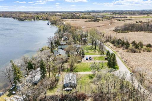 The canvas is here: generous acreage, direct lake access, mature trees, a private dead-end setting with no through traffic, and that coveted east-facing orientation that fills every morning with light off the water.