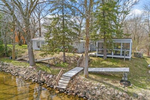 A few steps down the stone path and you're at the water's edge. That's it. That's the whole commute. This is what direct lake access feels like, effortless, immediate, and completely yours.