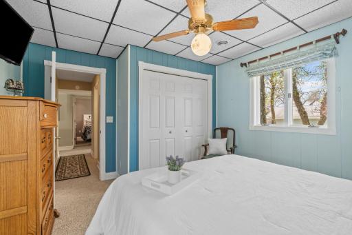 There's a warmth to this room that photographs can't fully capture, the way afternoon light filters through the windows and lands on the white bedding, telling you that rest is not only allowed, it's required.