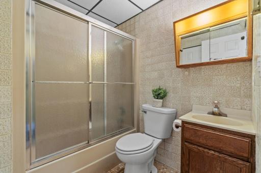 Rinse off the sunscreen and lake water in this full tub/shower combo, a hard-working bathroom that keeps up with the pace of full days outside and long evenings by the fire.