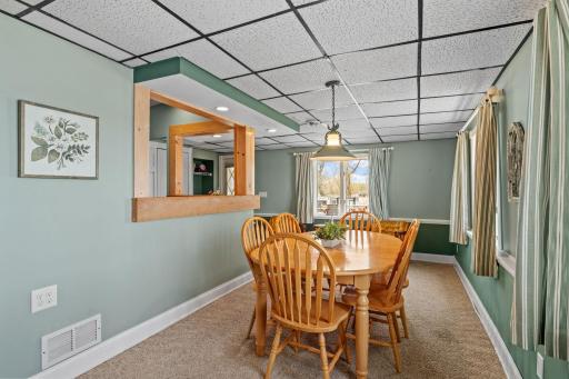 From the kitchen to the table without missing a beat, the clever pass-through window makes this dining room the social hub of the home. Set the table, light the pendant, and let dinner stretch past dark.