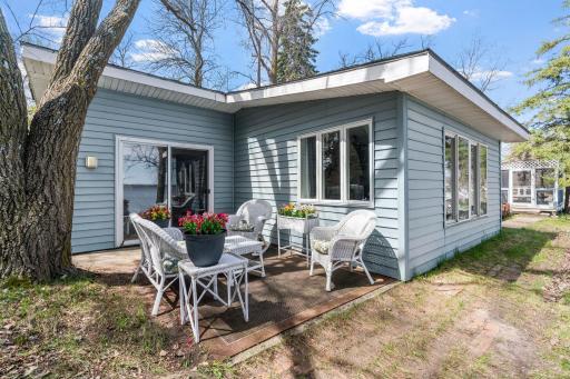 White wicker rocking chairs, fresh flowers, and an unobstructed view of the water. This little porch packs more peace per square foot than most places you'll ever sit.
