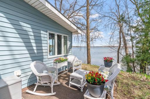 Morning coffee tastes better here. Fact. The east-facing orientation means the sun rises directly over the water and lands right on this porch first, a private sunrise show, every single day.