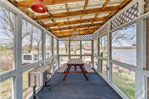 Bug-free and lake-facing, this screened porch is the secret weapon of this property. It's where card games go past midnight, where fish fry gets served on a Saturday, and where nobody wants to go inside.