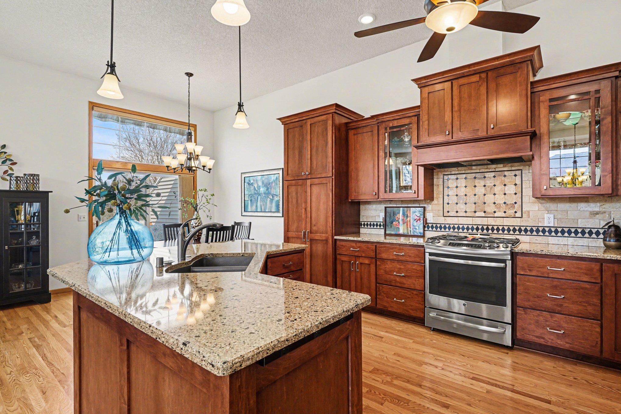 Custom kitchen cabinets has a lazy susan, pull-out cabinets throughout, trash center and a spice drawer.