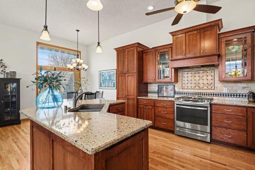 Custom kitchen cabinets has a lazy susan, pull-out cabinets throughout, trash center and a spice drawer.