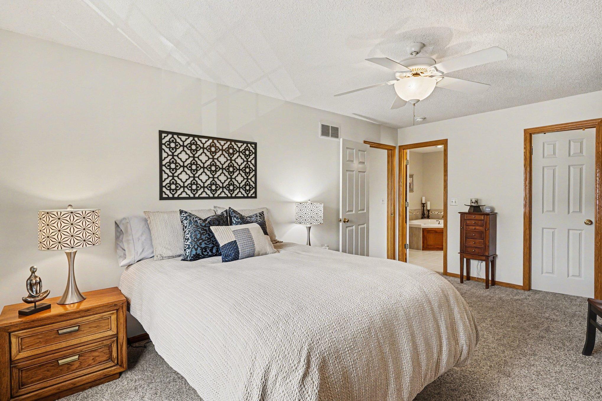 Another view of the primary bedroom shows access to the huge walk-in closet and a private primary full bath.