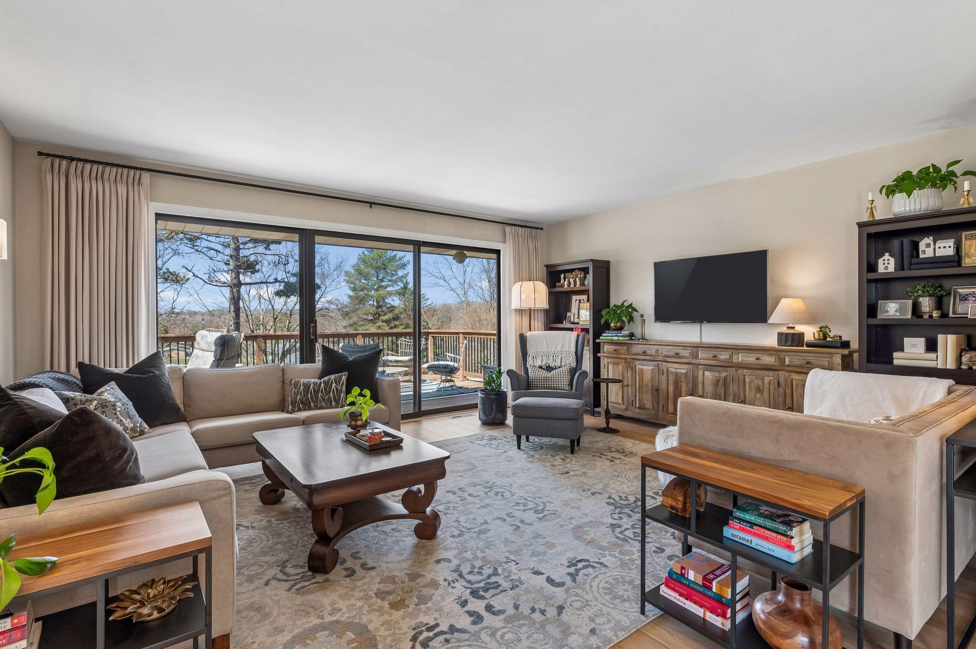 Living room large and bright, giant windows to lead to deck with open views to the west