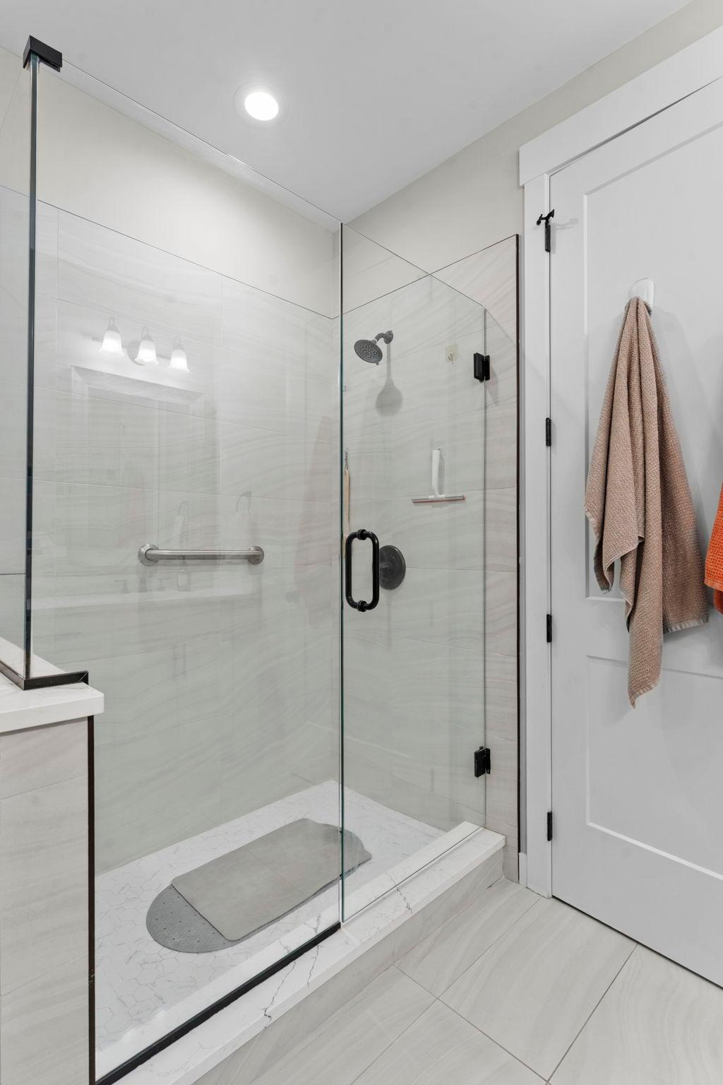 Primary bath shower with frameless glass surround