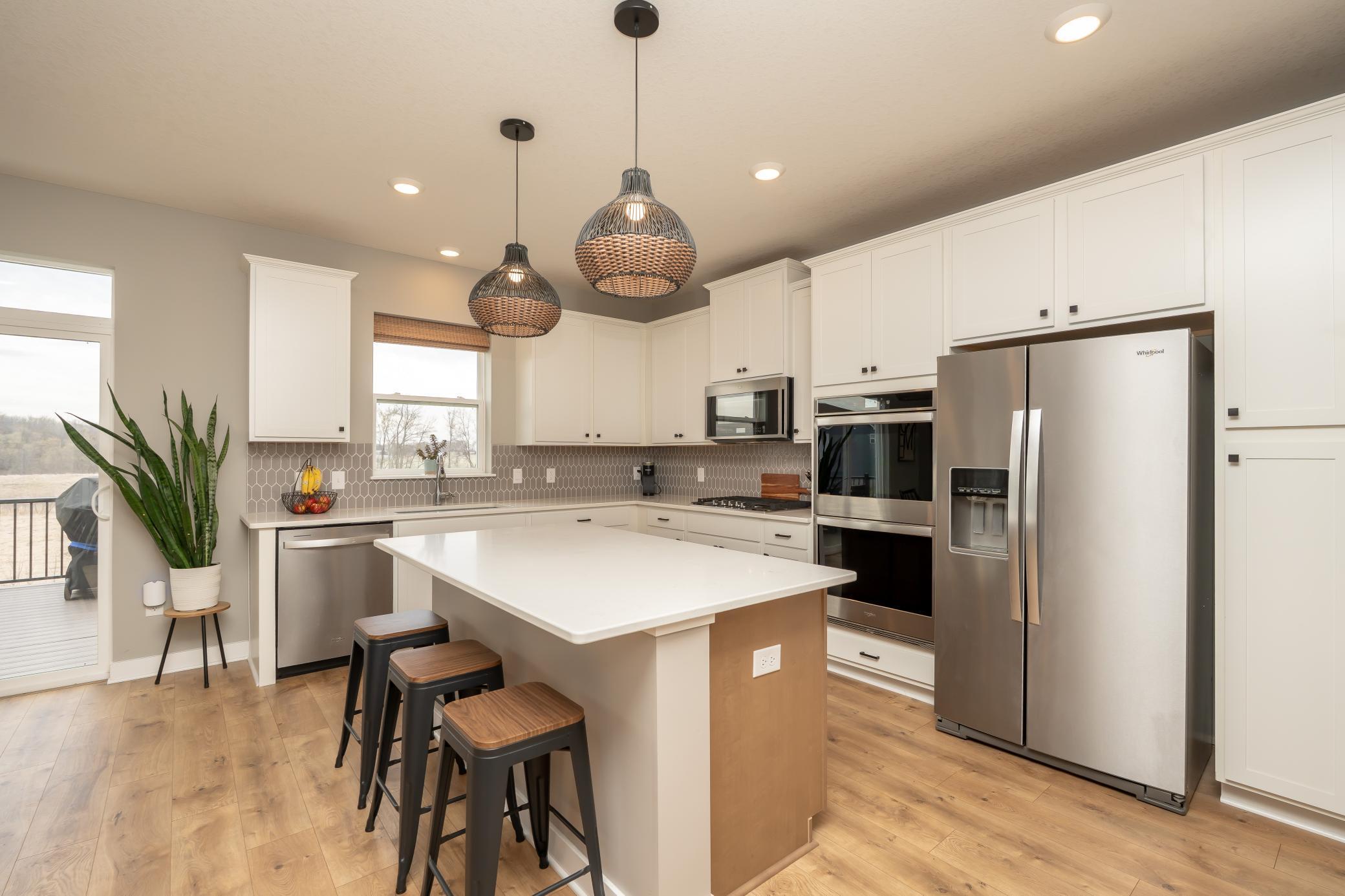Kitchen with stainless appliances, double ovens and big island