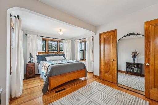Comfortable main level bedroom with hardwood floors and generous natural light.