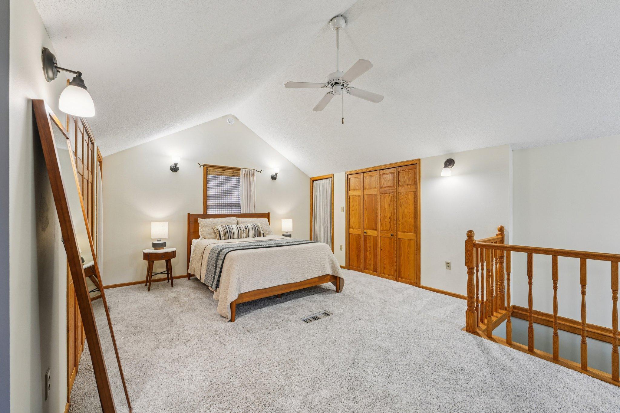 Private upper level owner’s suite with vaulted ceiling, plush carpeting, and excellent closet space.