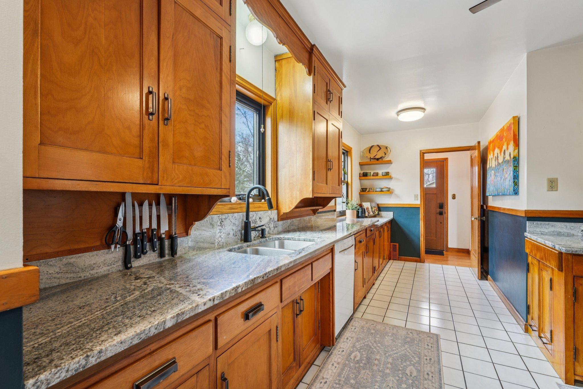 Updated kitchen with granite countertops, newer cabinetry, and abundant natural light overlooking the backyard.