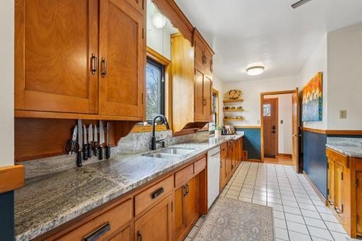 Updated kitchen with granite countertops, newer cabinetry, and abundant natural light overlooking the backyard.