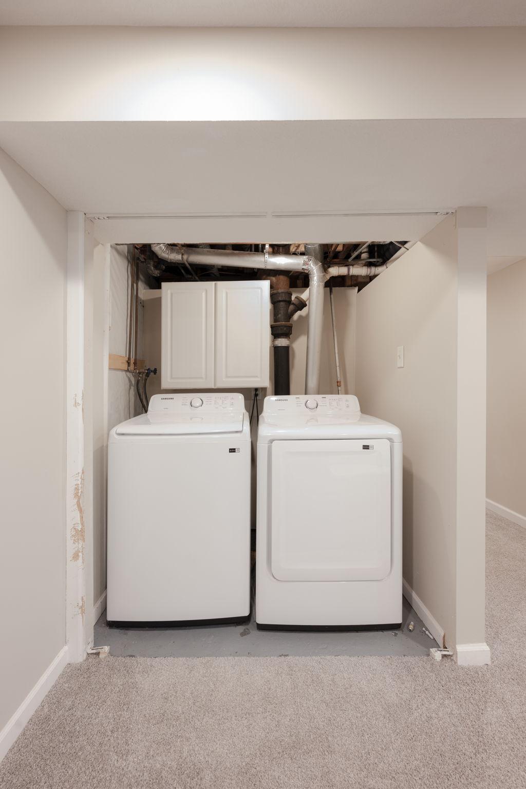 Lower level laundry with storage.