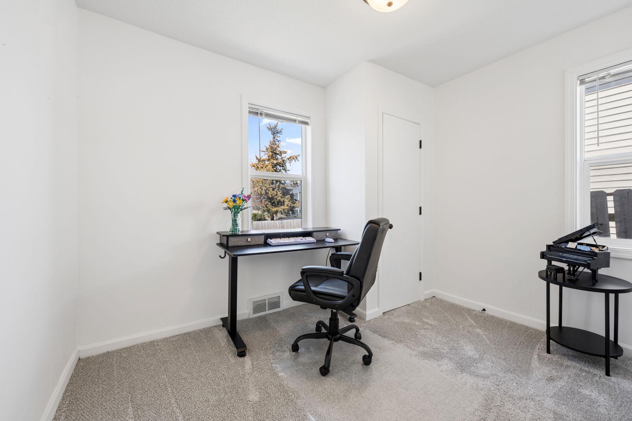 Additional main level bedroom is perfect for an in-home office!