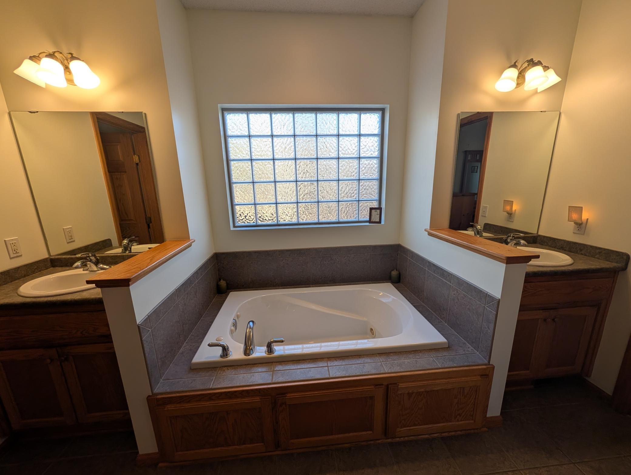 Primary bathroom with double sinks and jacuzzi tub
