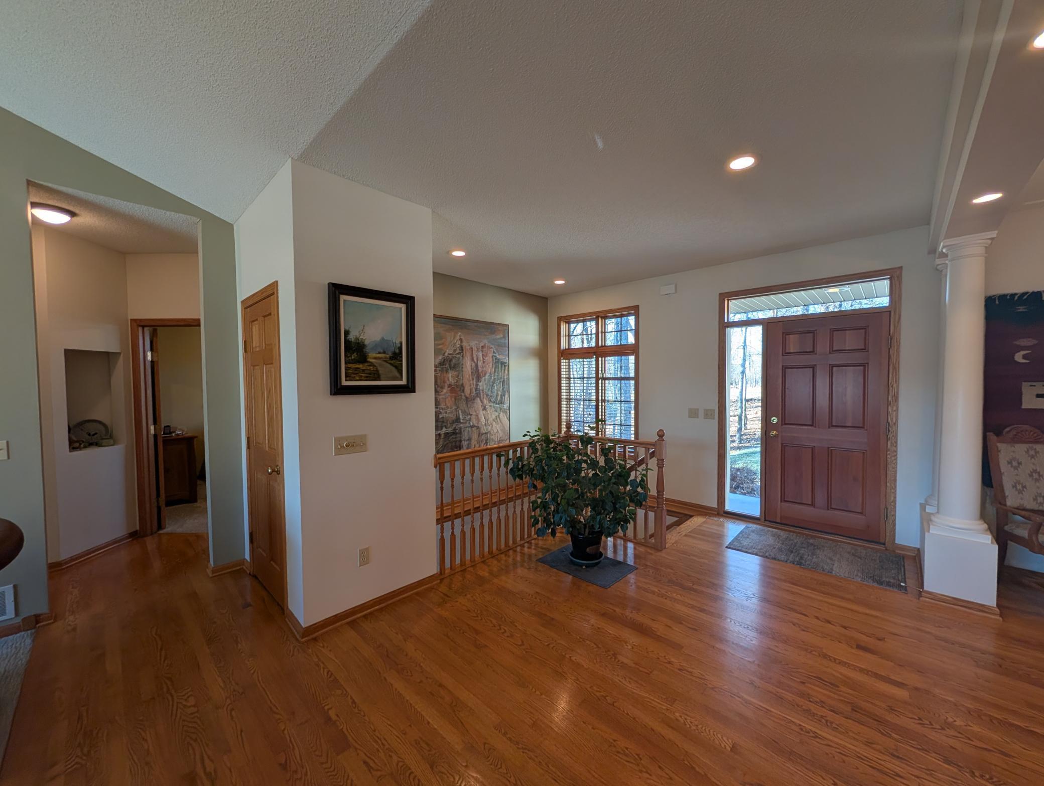Front entry and hallway to guest bedroom and full bathroom
