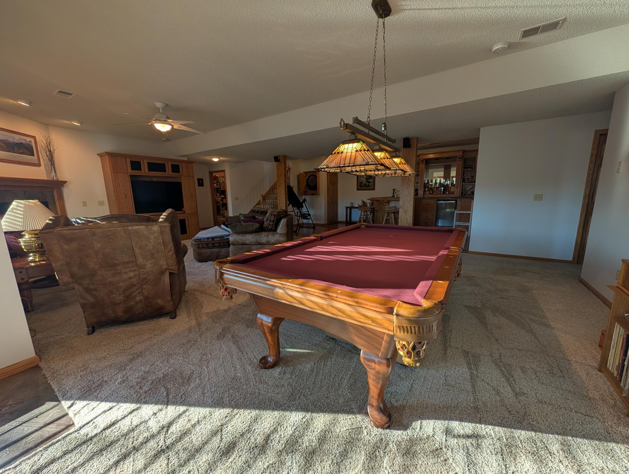 Pool table and views to wet bar and entertaining area