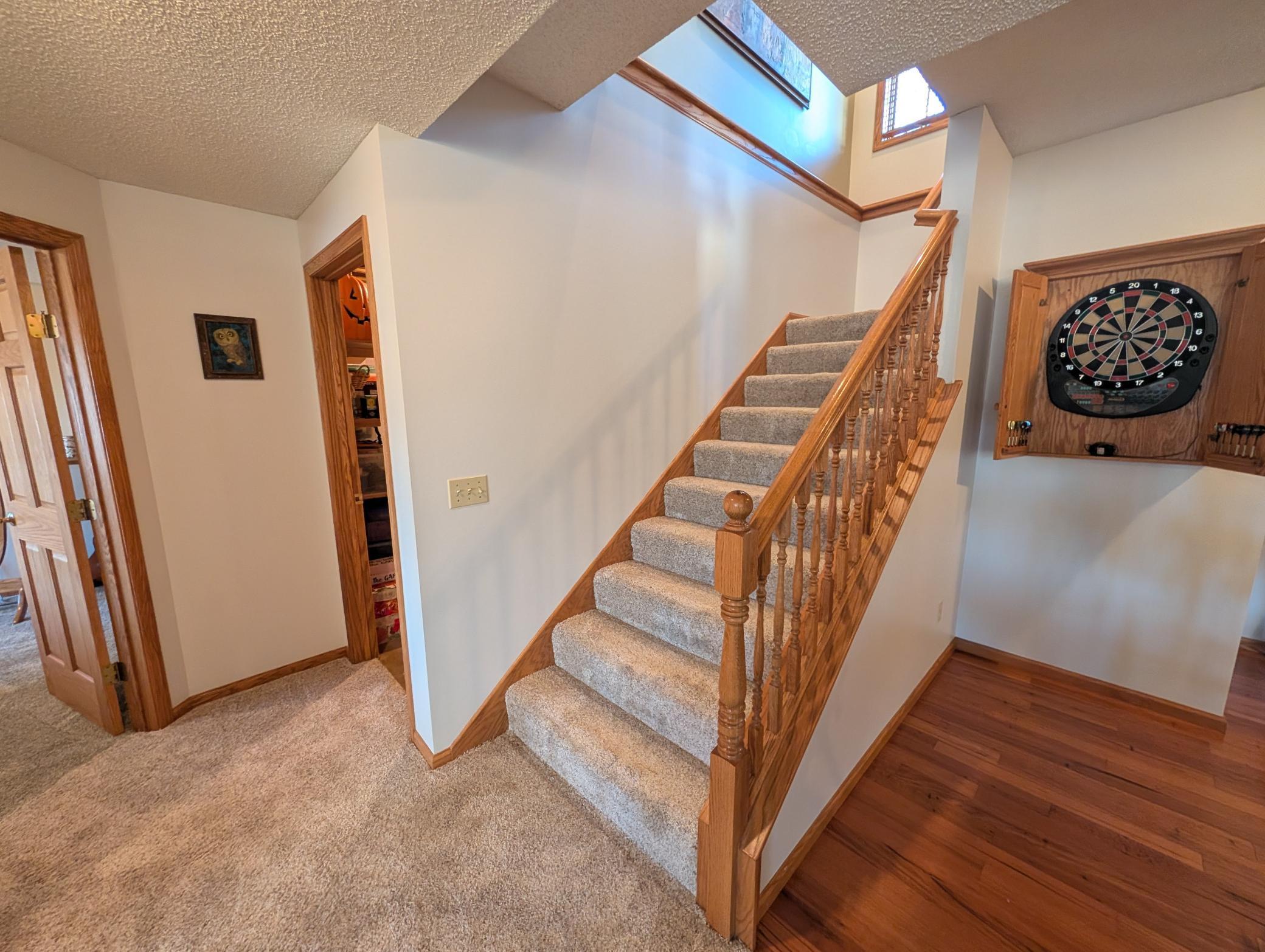 Stairway and doorway to large storage area in the lower level