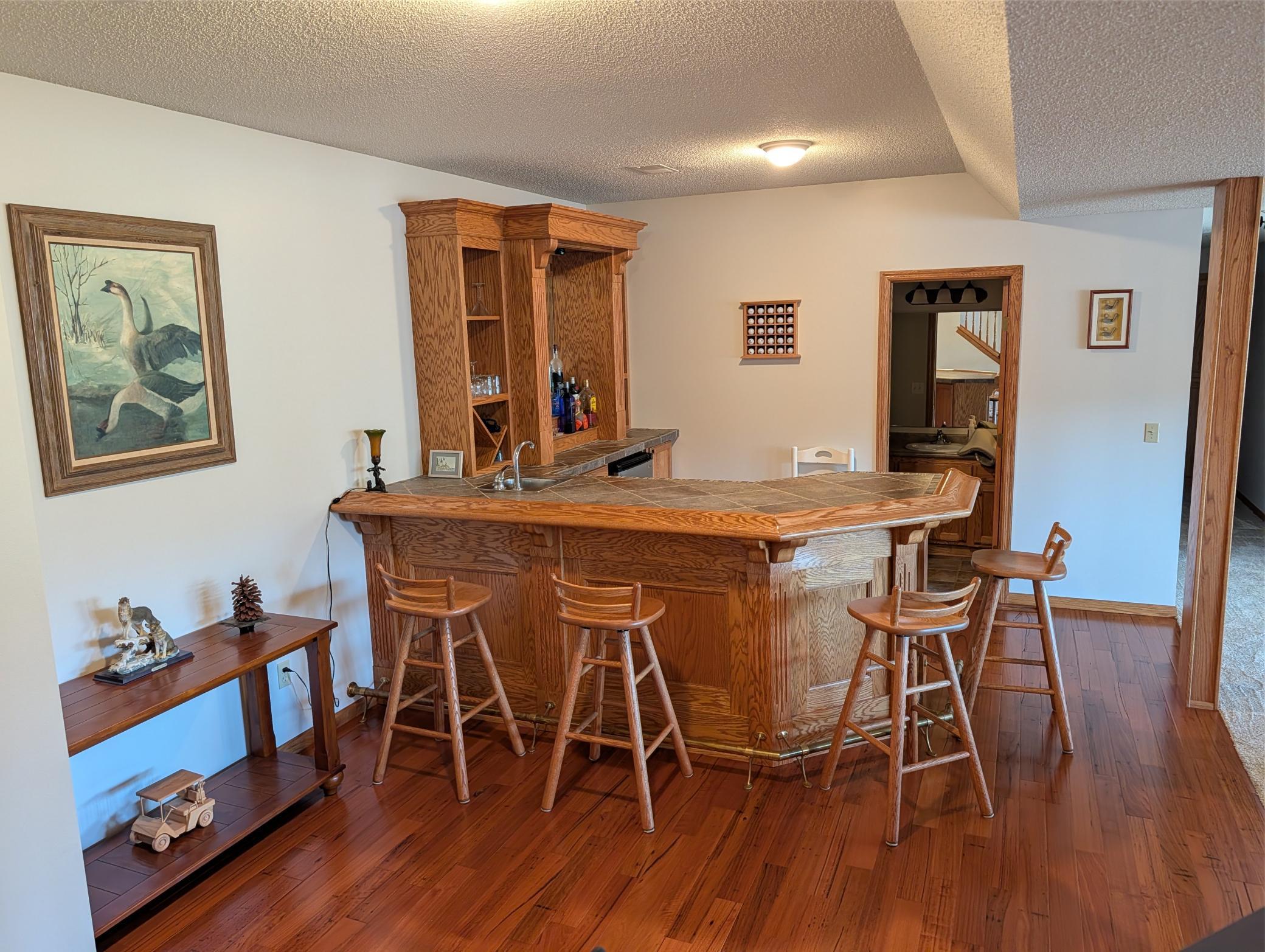 Custom cabinet bar with wood floor. Great for entertaining!