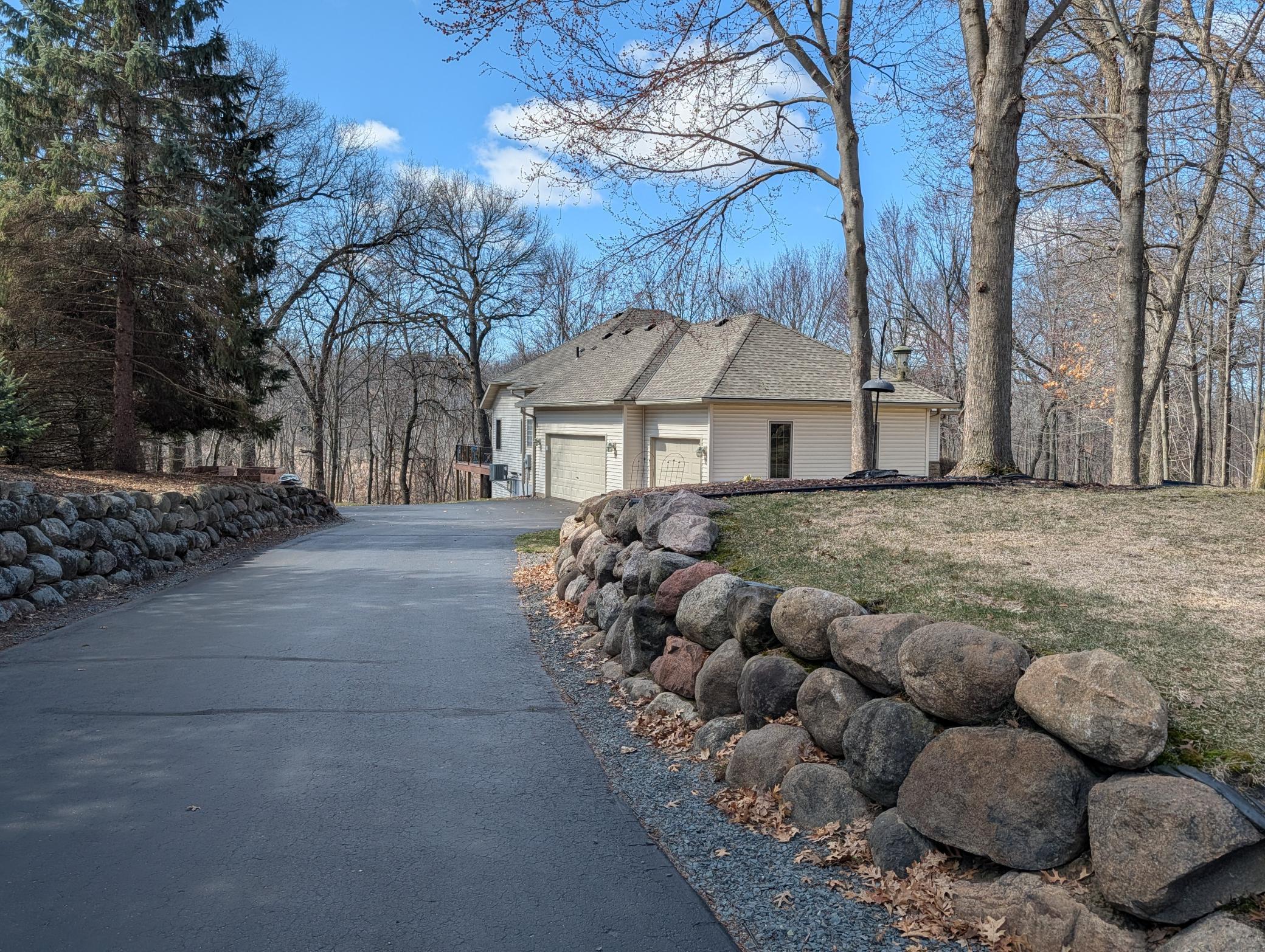 Side entry large garage with boulder lined driveway