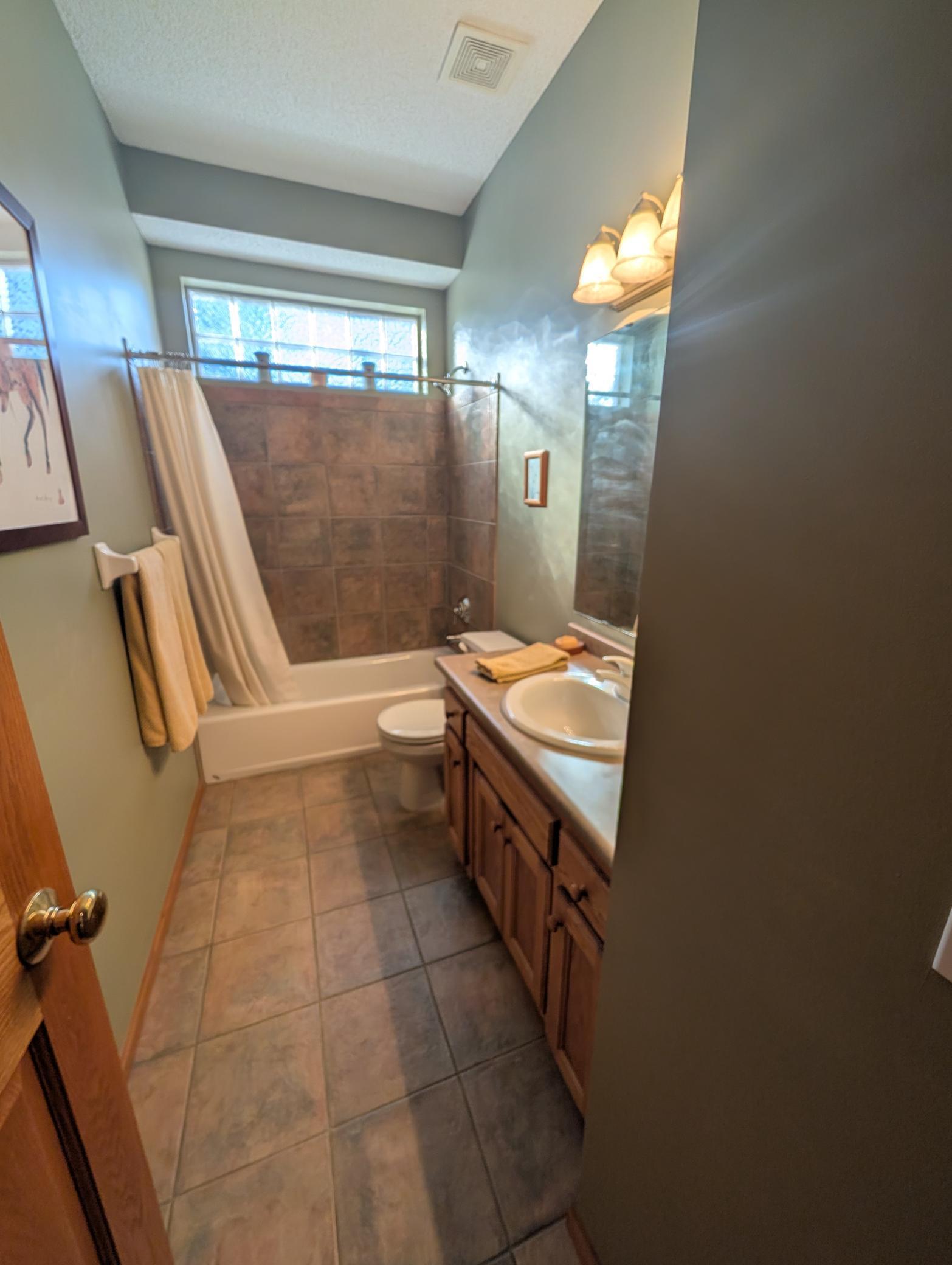 Guest full bathroom on main level right next to the guest bedroom