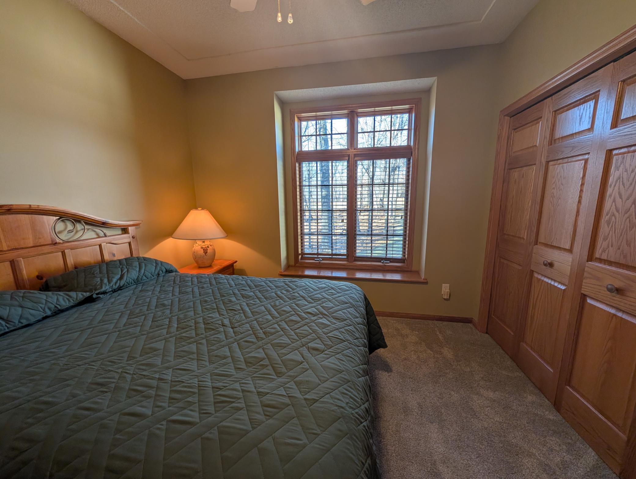 Guest bedroom on main level with views of the front yard