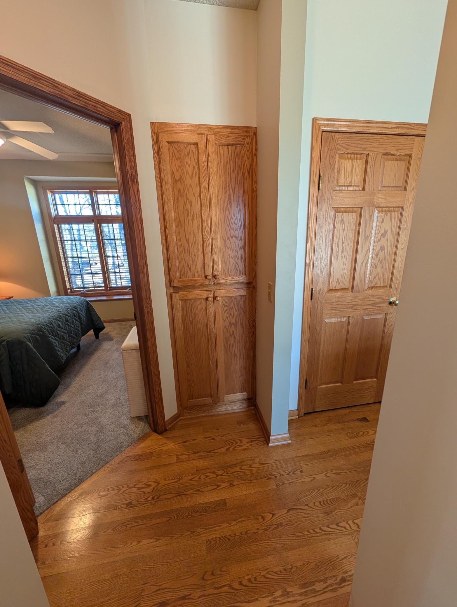 Hallway from guest bedroom to full bathroom. This home has numerous locations for storage!