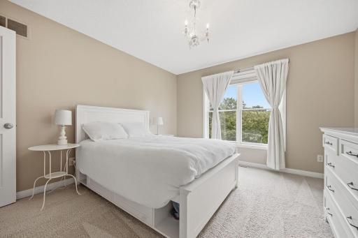 Bedroom with large window and ample closet