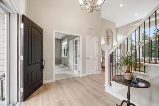 As you enter the foyer, you will see an elegant staircase complete with custom wrought iron