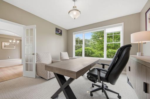 This room has large windows viewing the beautiful front yard and the lush backyard