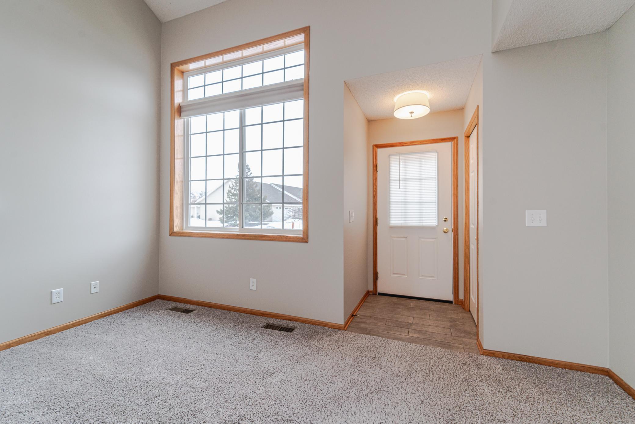 Oversized windows including a transom in the living room bring in a lot of southern light to this home.