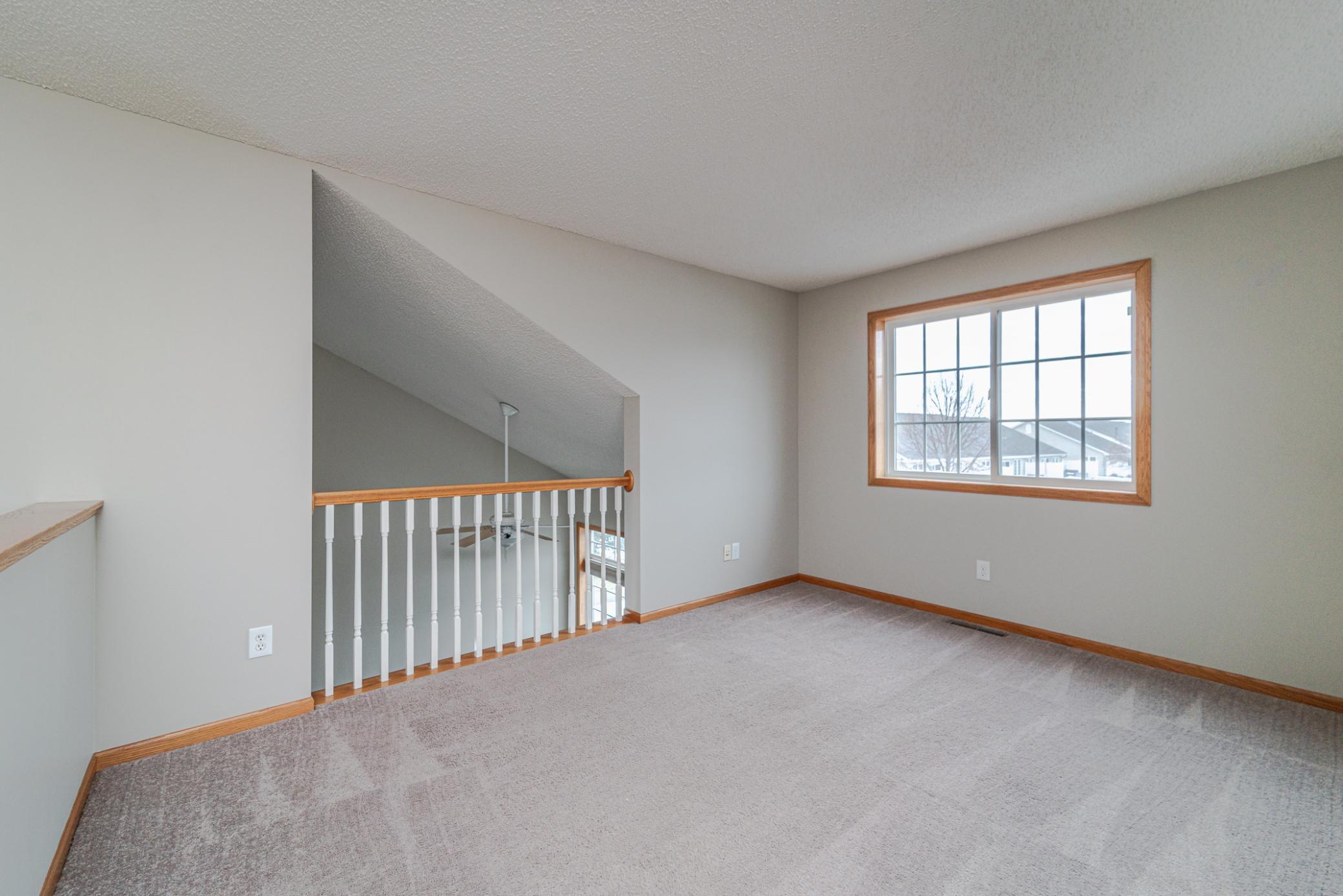 The loft on the upper level has been freshly painted. It overlooks the family room and has bright windows letting i the southern light.