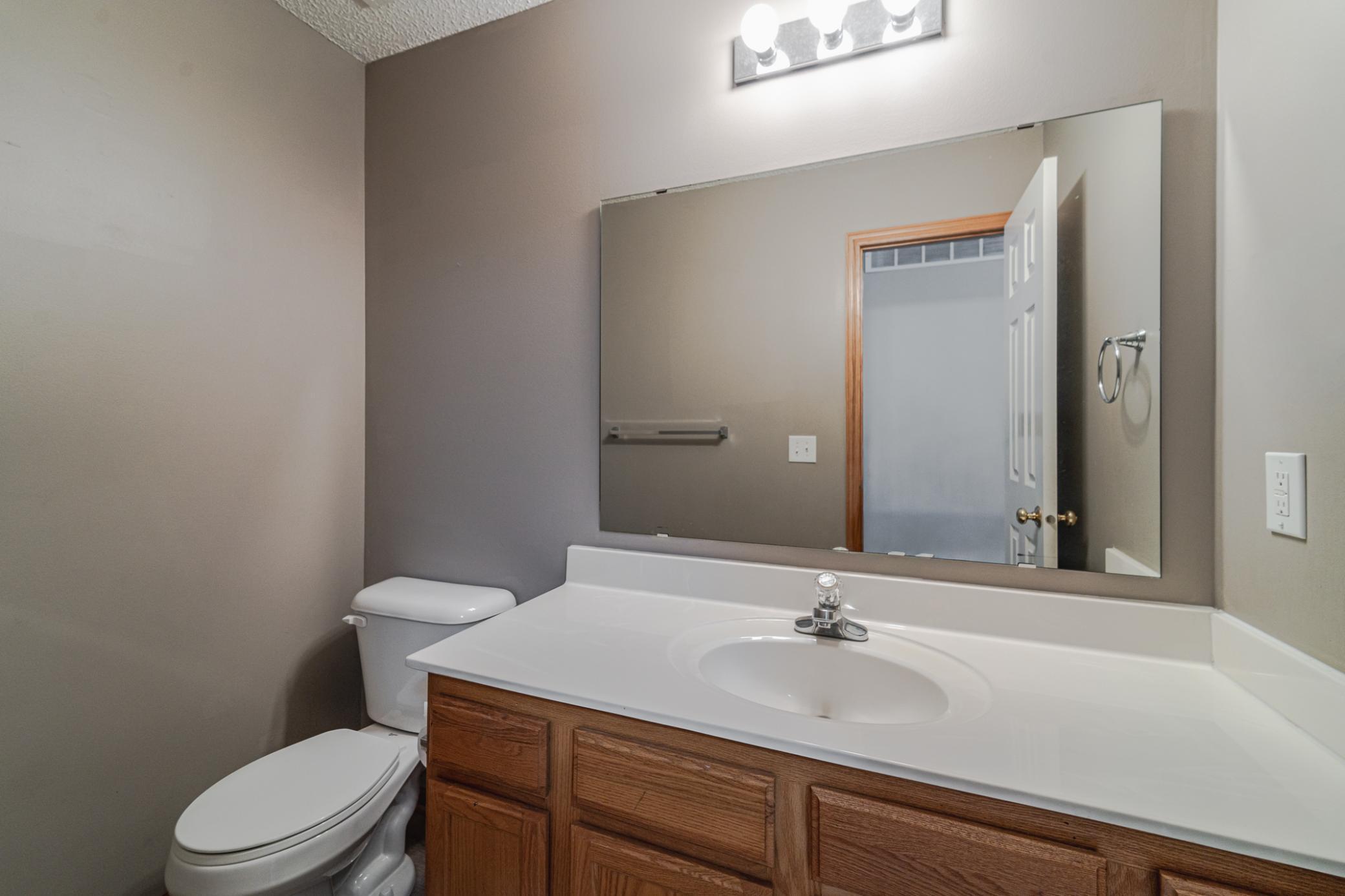 The main floor half bath has neutral paint and is ready for your decor! This bath has a spacious vanity top space.