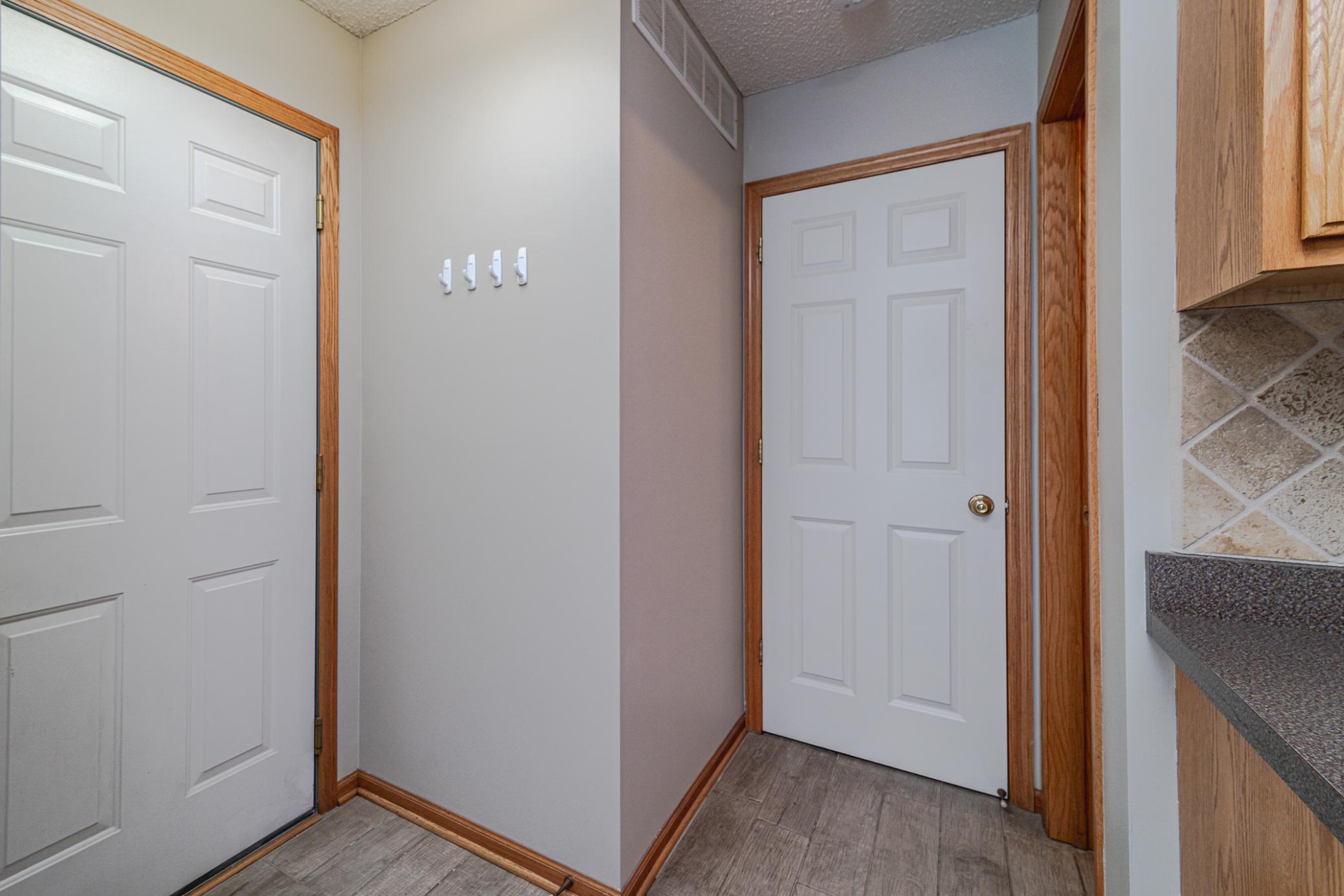 The rear entry has the garage access (left) - mechanical room (middle) - and half bath (right).