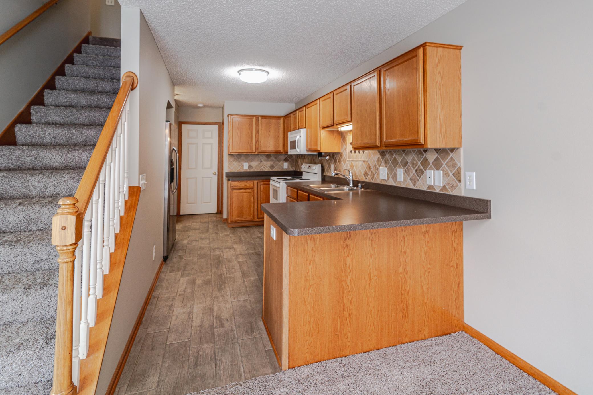 The kitchen has INCREDIBLE countertop space and ceramic plank flooring.