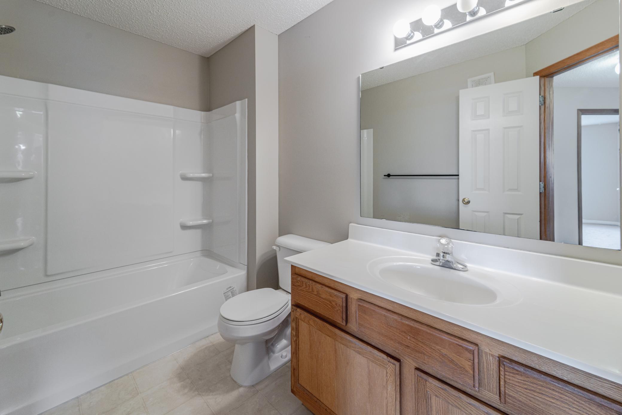 The main floor has a half bath, and the FULL upper level bath has a BRAND NEW, NEVER USED TUB/SHOWER SURROUND, SHOWER HEAD, FAUCET and FRESH PAINT!