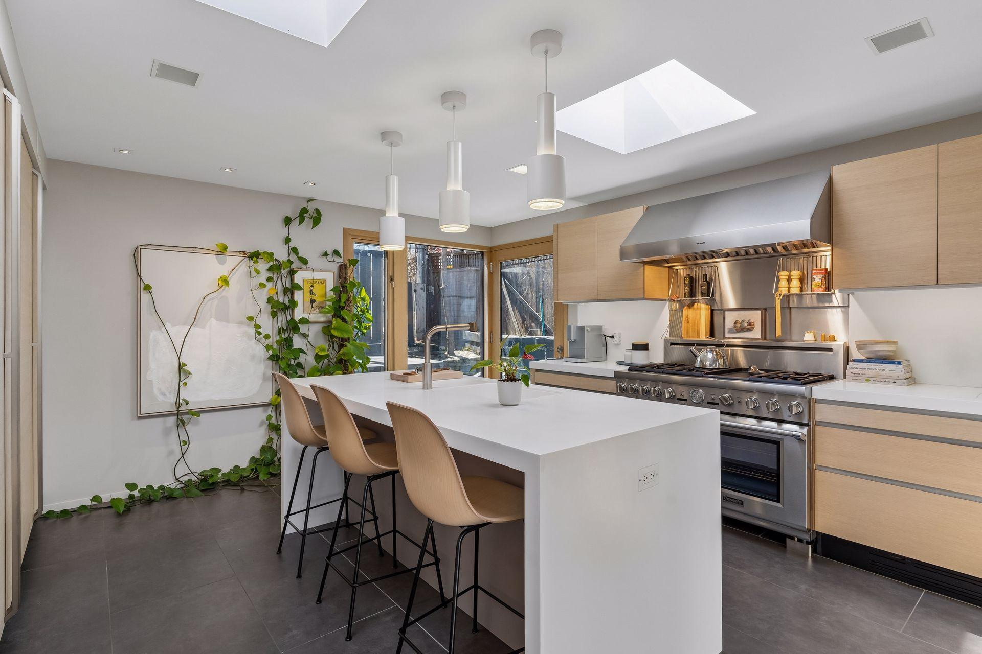 Contemporary, minimalist kitchen has Italian Valcucine cabinets, Dornbracht fixtures, commercial-grade 48 inch gas range.