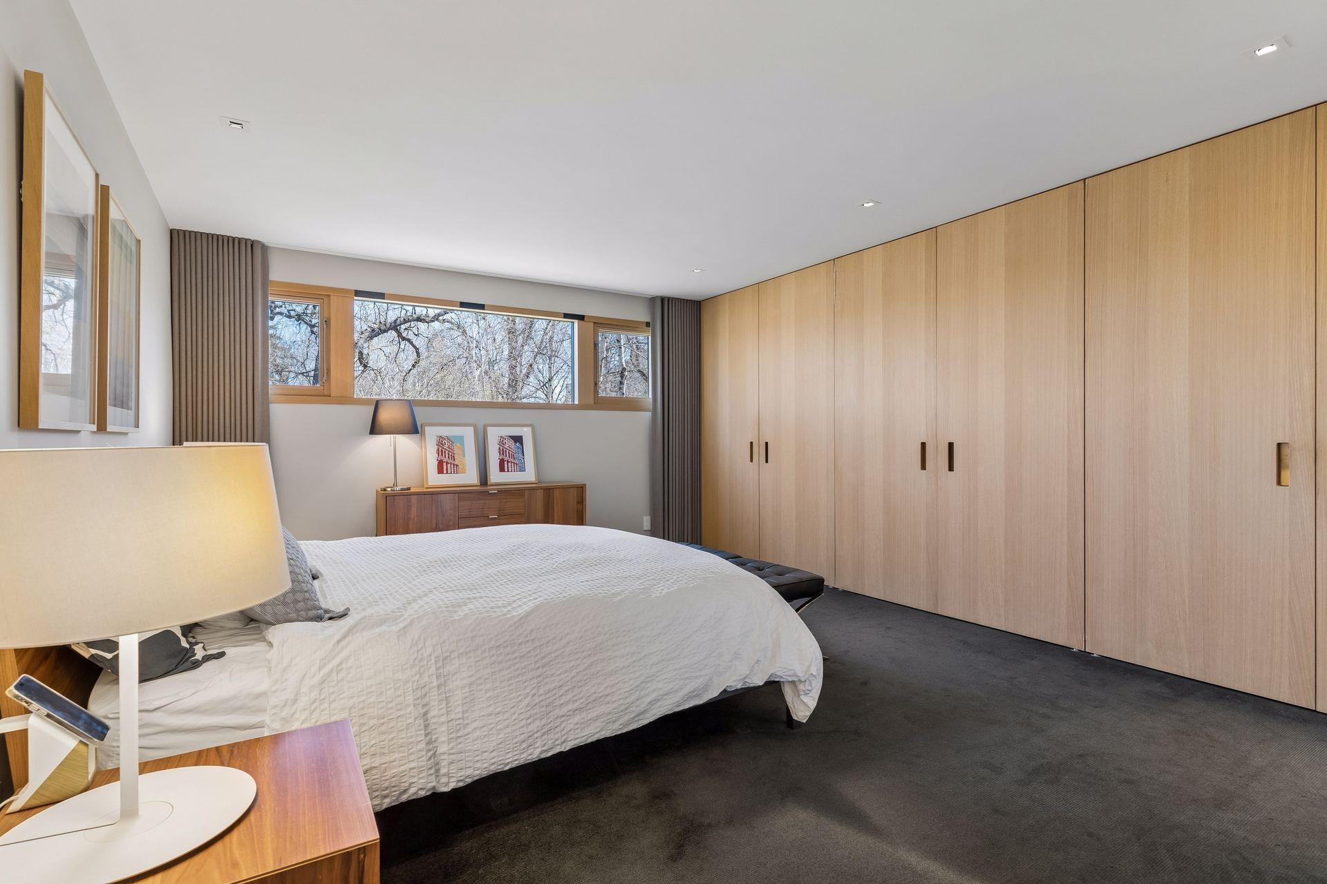 Large owners suite with a wall of built in cabinets.