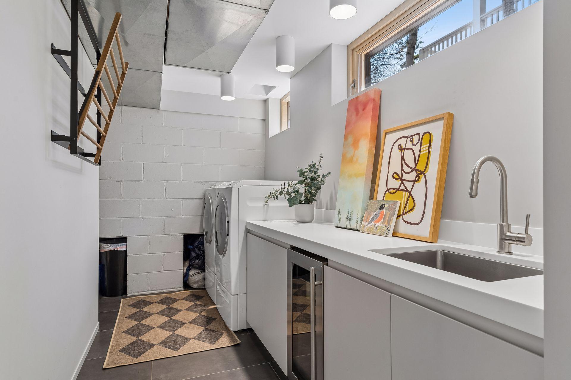 Large laundry room with custom built storage cabinets.
