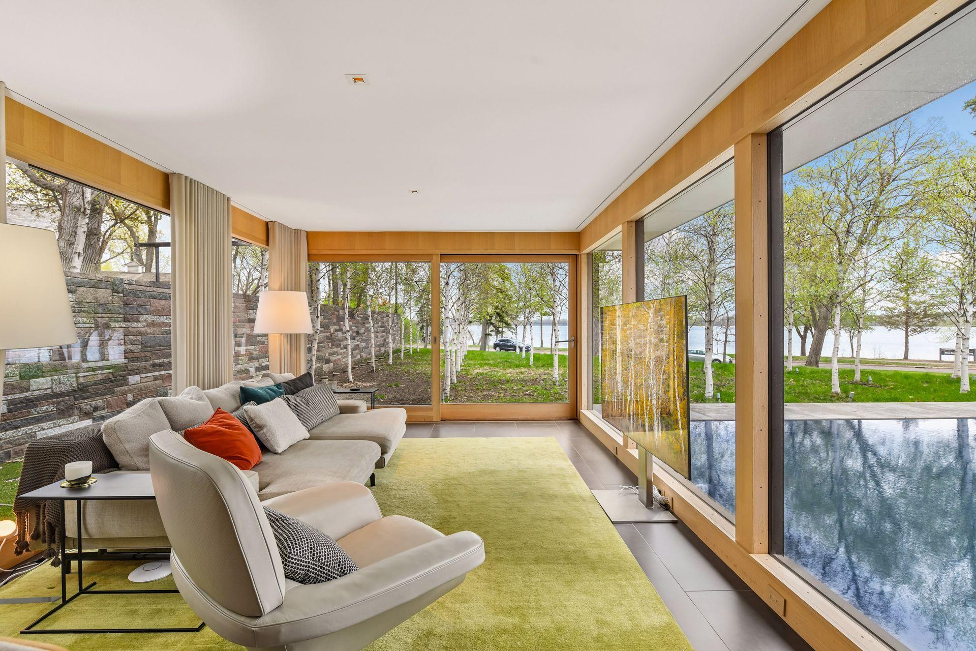 Oversized family room with amazing lake and reflective pool views.