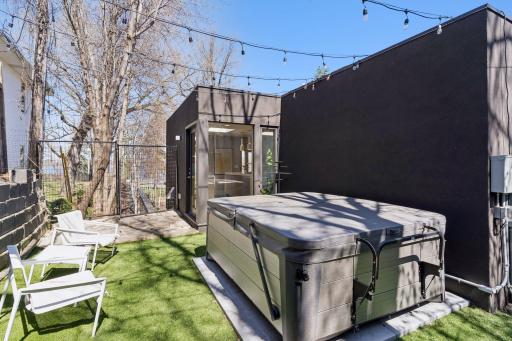 Private outdoor space off the kitchen has a hot tub and lake views.