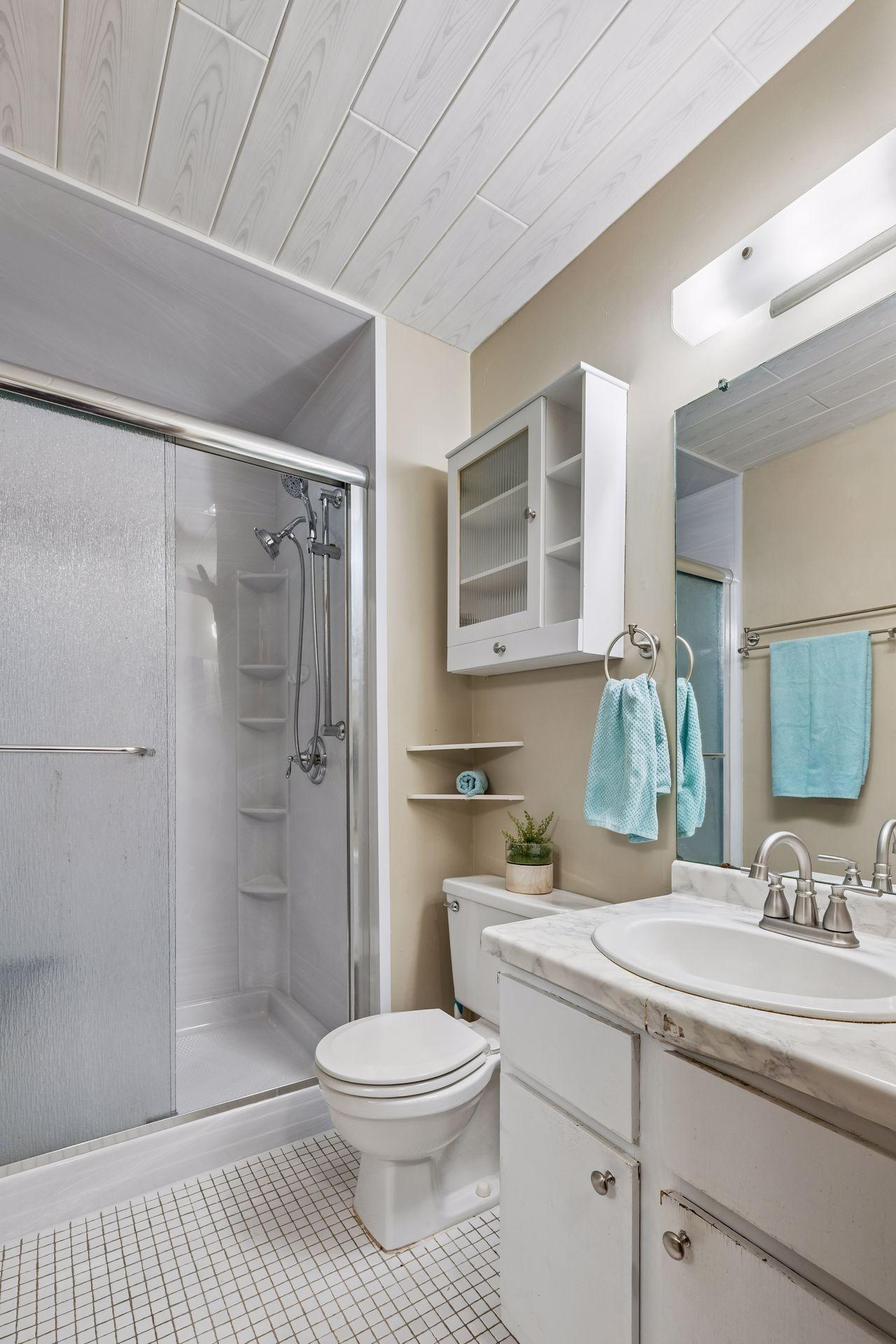 Primary Bathroom with large glass-enclosed Bathroom